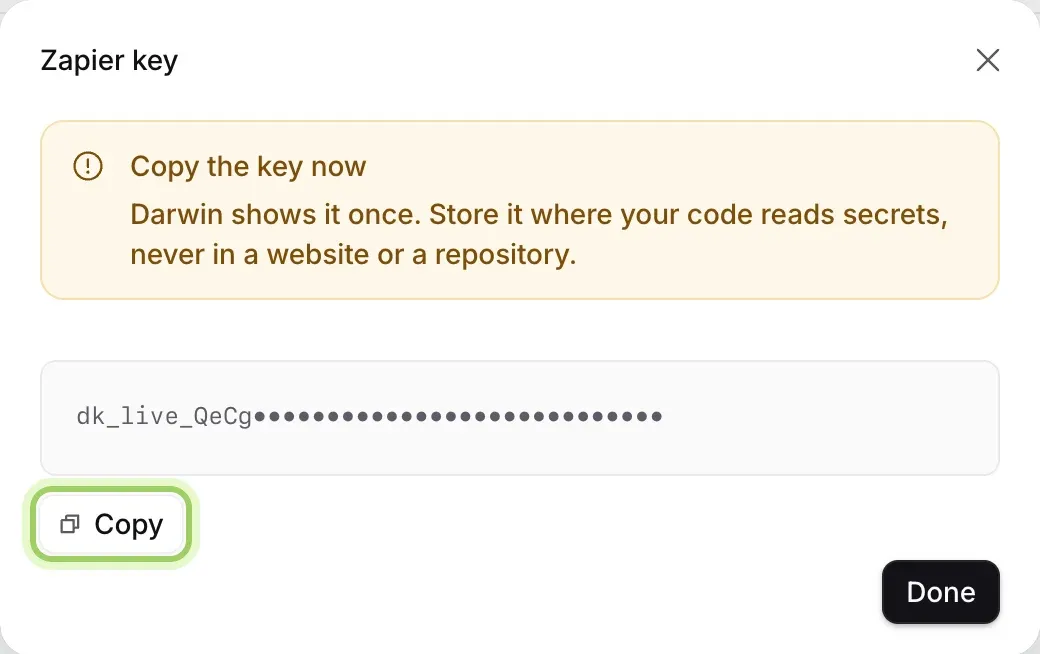 The Zapier key dialog: Copy the key now, Darwin shows it once, the key itself hidden here after its first characters, and the Copy button highlighted.